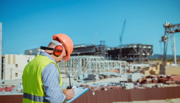Portrait of a male engineer on a construction site background - Zdjęcie, obraz