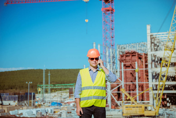 Portrait of a male engineer on a construction site background - Photo, Image