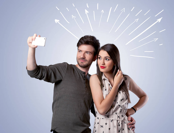 Cute couple taking selfie with arrows - Fotografie, Obrázek
