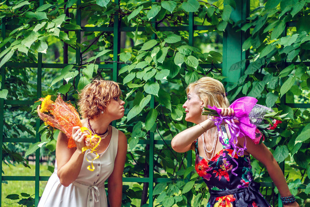 Two girlfriends are having fun in the city park. - 写真・画像