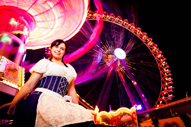 Young Woman Sitting Next To Carousel - Photo, Image