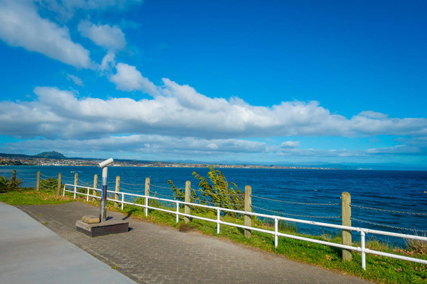 NORTH ISLAND, NEW ZEALAND- MAY 18, 2017: Beautiful view of wharf, and lovely view of Lake Taupo with mountains an city in the background at spring, North Island of New Zealand with beautiful blue sky - Photo, image