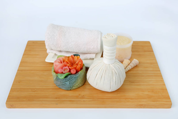 Spa herbal compressing ball with towels and Salt Scrub, Spa concept on bamboo board against white background - Foto, imagen