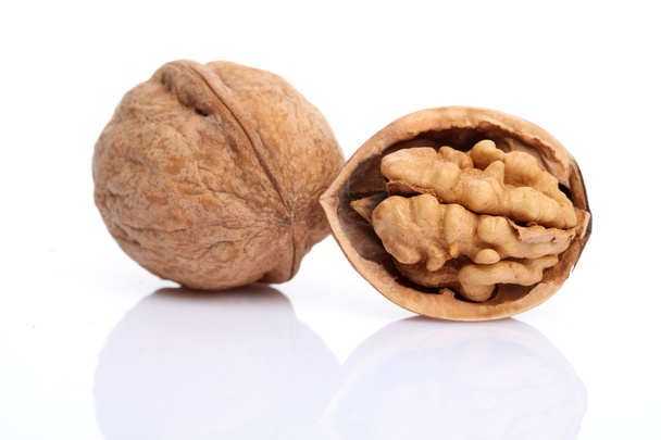 Walnut and a cracked walnut isolated on the white background - Fotoğraf, Görsel