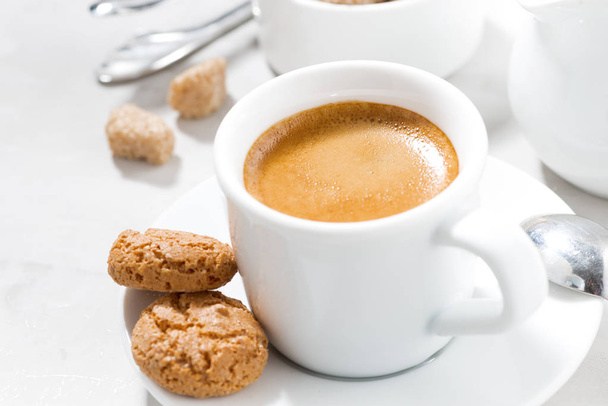 cup of espresso and almond cookies on a white table, closeup - Foto, imagen