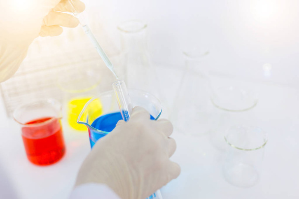 scientist hand holding laboratory test tube, science laboratory  - 写真・画像