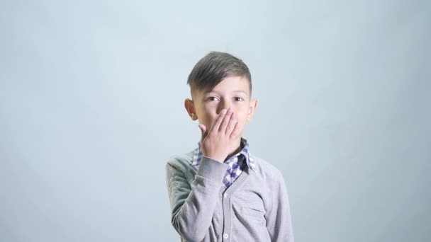 The boy sends an air kiss and shows class. White isolated studio shot - Filmmaterial, Video
