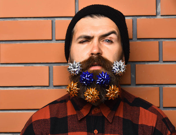 Bearded man with flowers or bows in long beard - Foto, Imagem