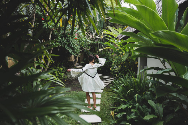 Woman walking in tropical garden - Fotó, kép