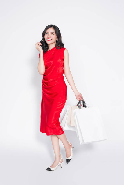 woman  in red dress with shopping bags - Foto, Imagen