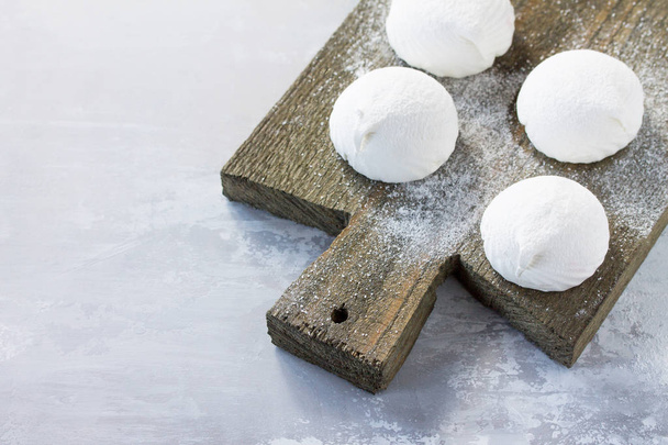 Delicate vanilla marshmallows on a vintage stone background. - Photo, image