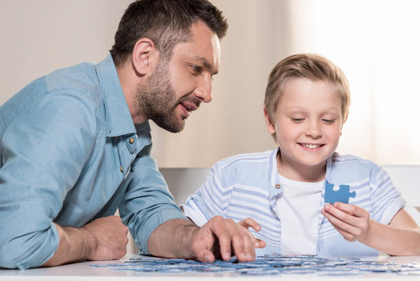 man playing puzzle with son - Photo, Image