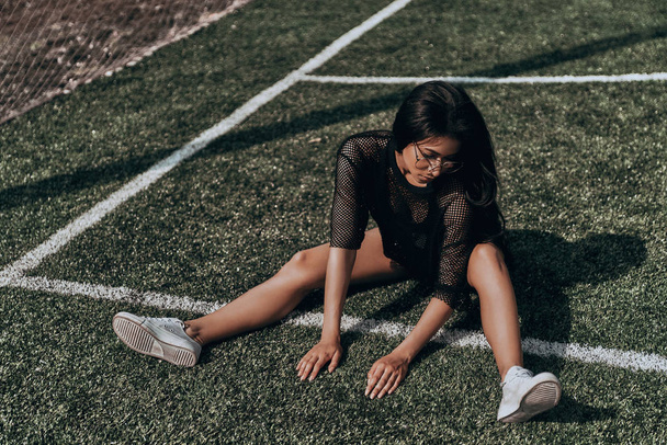 woman sitting on soccer field - Photo, Image