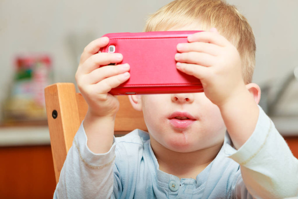 Little boy using smartphone playing games - Photo, image