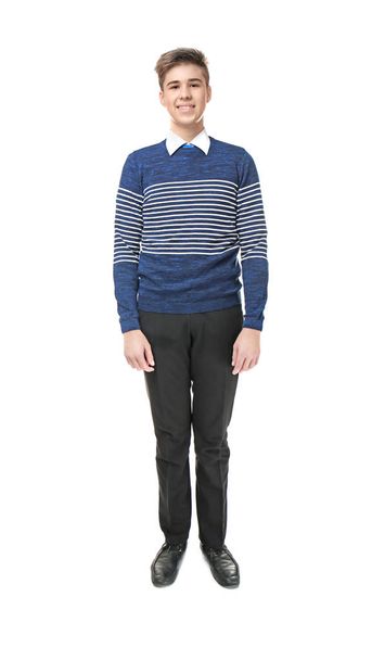 Cheerfully smiling school boy standing on light background - Photo, Image