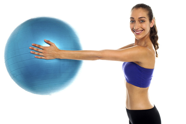 Fitness enthusiast holding a swiss ball - Zdjęcie, obraz
