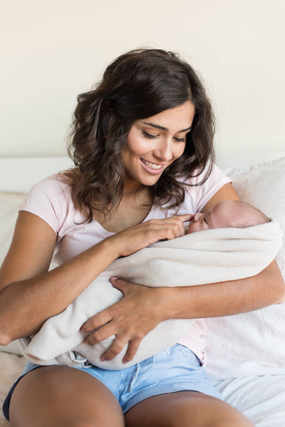 Mother holding newborn baby - Фото, изображение