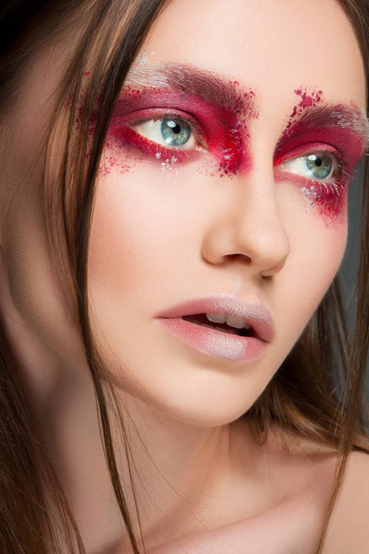 Beautiful woman face portrait close up with red make up - 写真・画像