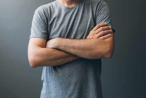 Casual adult man with arms crossed, body language - Foto, afbeelding