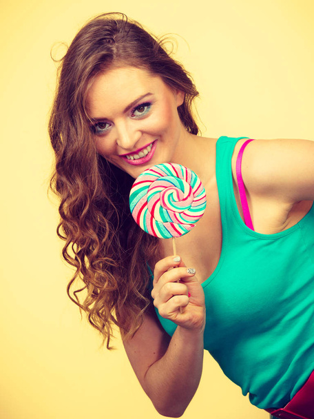 Woman charming girl with lollipop candy - Fotó, kép