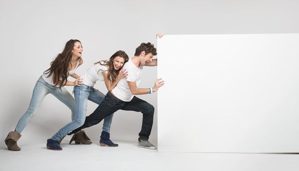 Young pushing white board - Photo, image