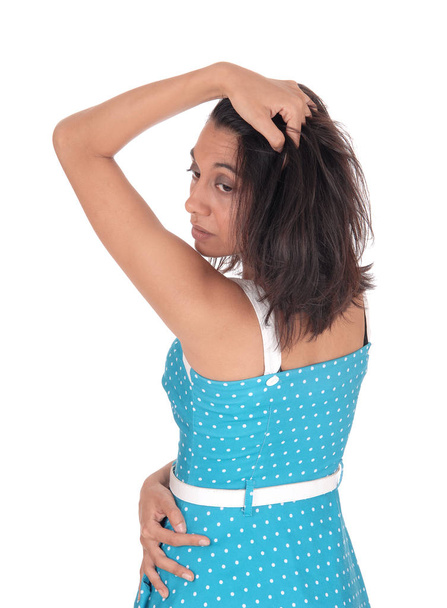 Hispanic woman in blue dress from the back. - Photo, image