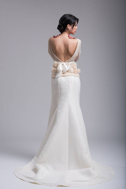 Rear view of a beautiful young woman in a wedding dress - Zdjęcie, obraz