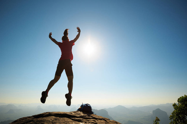 woman jumping on mountain top  - Foto, Imagem