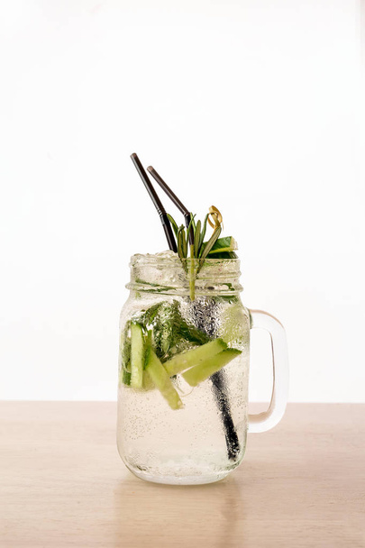 A cool drink of Mojito on the table. White backdround - Foto, imagen