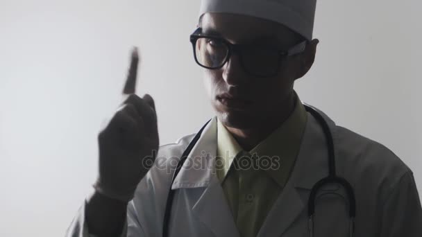 winkt der Arzt bedrohlich mit dem Zeigefinger. Strenge medizinische Betreuung - Filmmaterial, Video