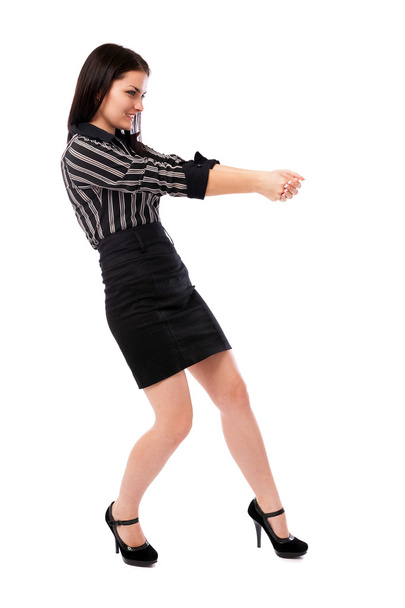 Young businesswoman pulling an imaginary rope - Foto, imagen