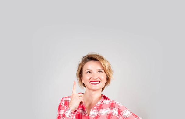 Beautiful business woman showing finger up and smiling looking up - Фото, изображение