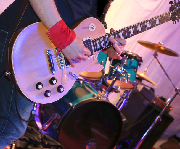 Gitarrist spielt während eines Live-Konzerts auf der Bühne E-Gitarre - Foto, Bild
