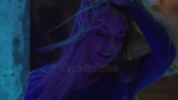 Seductive female enjoying dance and playing blond hair at night club, slow-mo - Кадри, відео