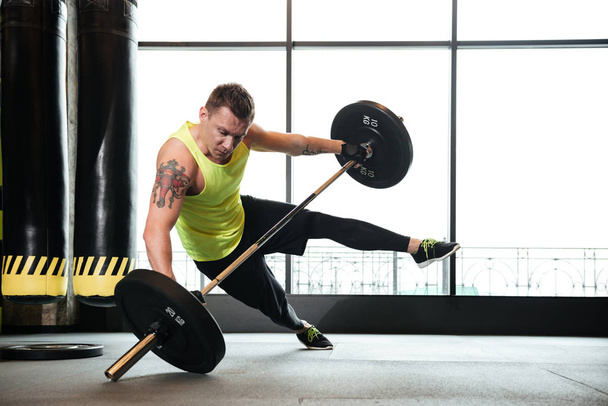 Serious sportsman make sport exercises in gym - Foto, imagen