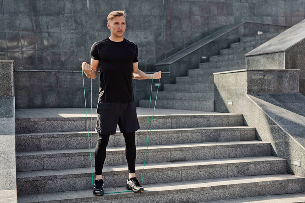 sportive man standing on stairs - 写真・画像