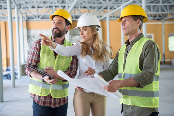 builders and contractor talking on construction site - Photo, Image