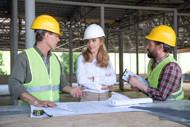 builders and contractor talking on construction site - Photo, Image