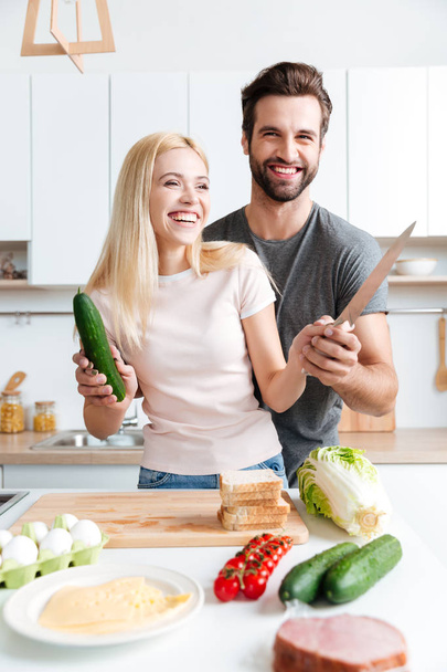 Couple cooking together in the modern kitchen - Foto, Bild