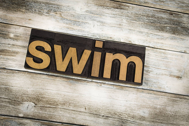 Swim Letterpress Word on Wooden Background - Photo, Image