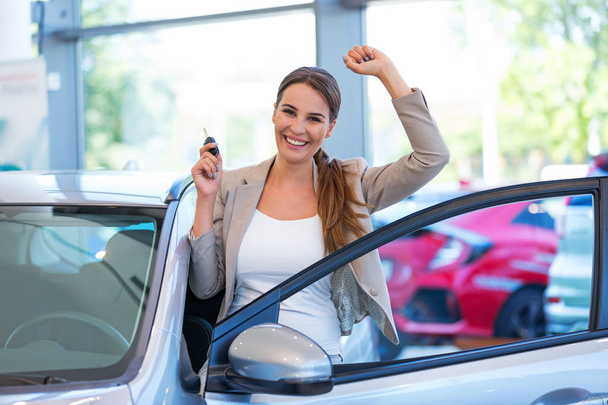 Happy young woman with her new car - Photo, Image