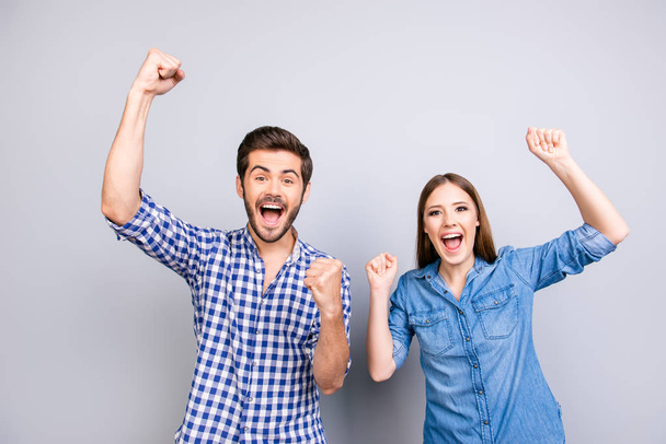 Yes! We did it! Cheerful couple is celebrating with raised hands - Foto, afbeelding