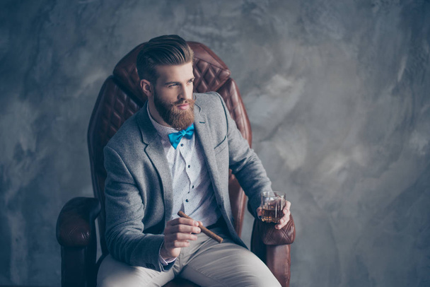 Portrait of handsome elegant young red bearded man holding glass - Foto, Bild