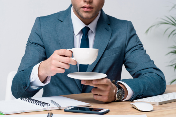 Молодой бизнесмен пьет кофе
 - Фото, изображение