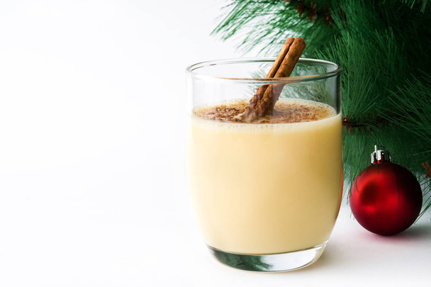 Homemade eggnog with cinnamon isolated on white background. Typical Christmas dessert. - Foto, imagen