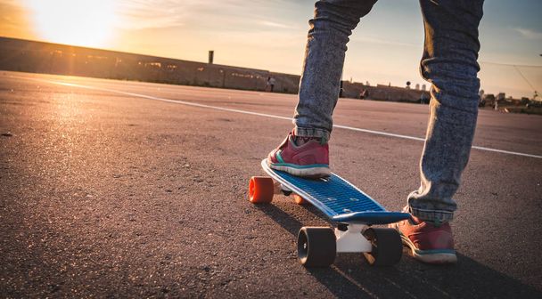 closeup of the feet on the skateboard on the pavement - 写真・画像