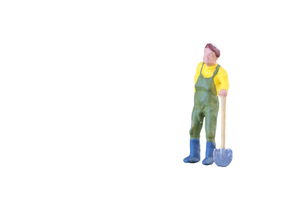 Close up of Miniature farmer people isolated with clipping path on white background  - 写真・画像