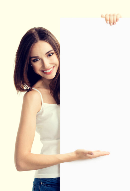 Brunette woman in casual clothing showing blank signboard - Zdjęcie, obraz
