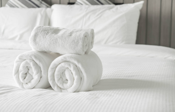 White towel on bed decoration in bedroom interior  - Foto, afbeelding