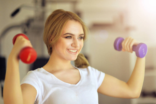 young woman training in gym - Фото, изображение
